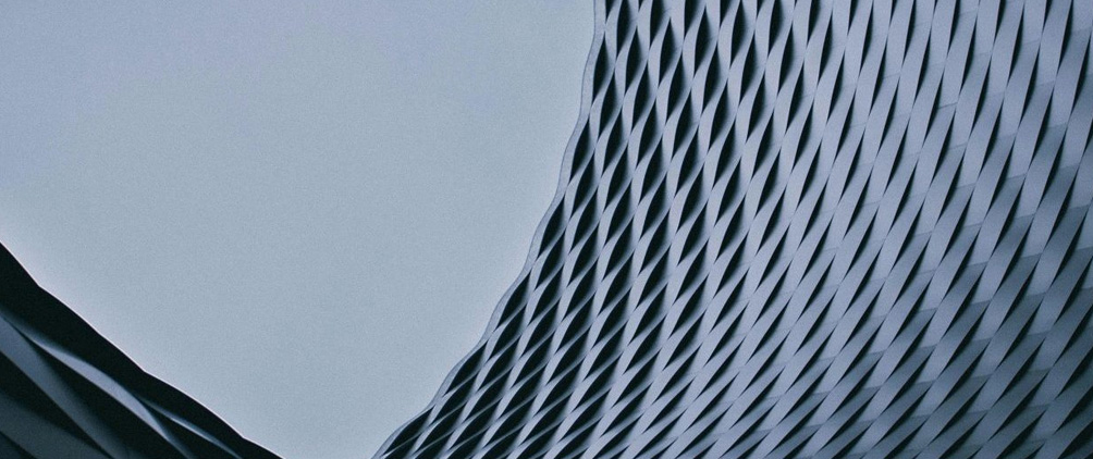 Abstract blue-gray architectural building facade representing StepStone’s Spring 2026 real estate market outlook.