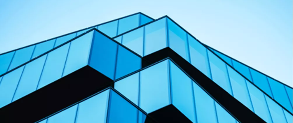 Blue glass building facade representing MetLife Investment Management’s Q1 2026 private credit quarterly review and outlook.
