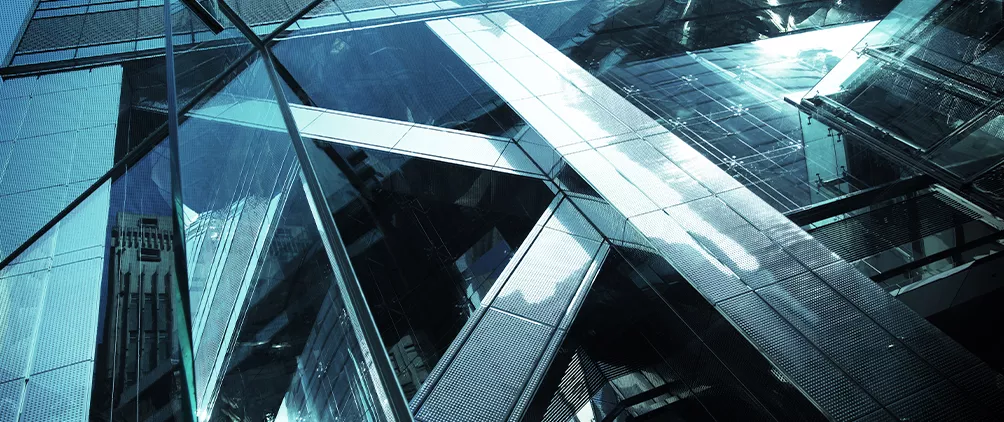 Blue-toned glass building facade representing Barings’ global direct lending strategy and private finance platform.
